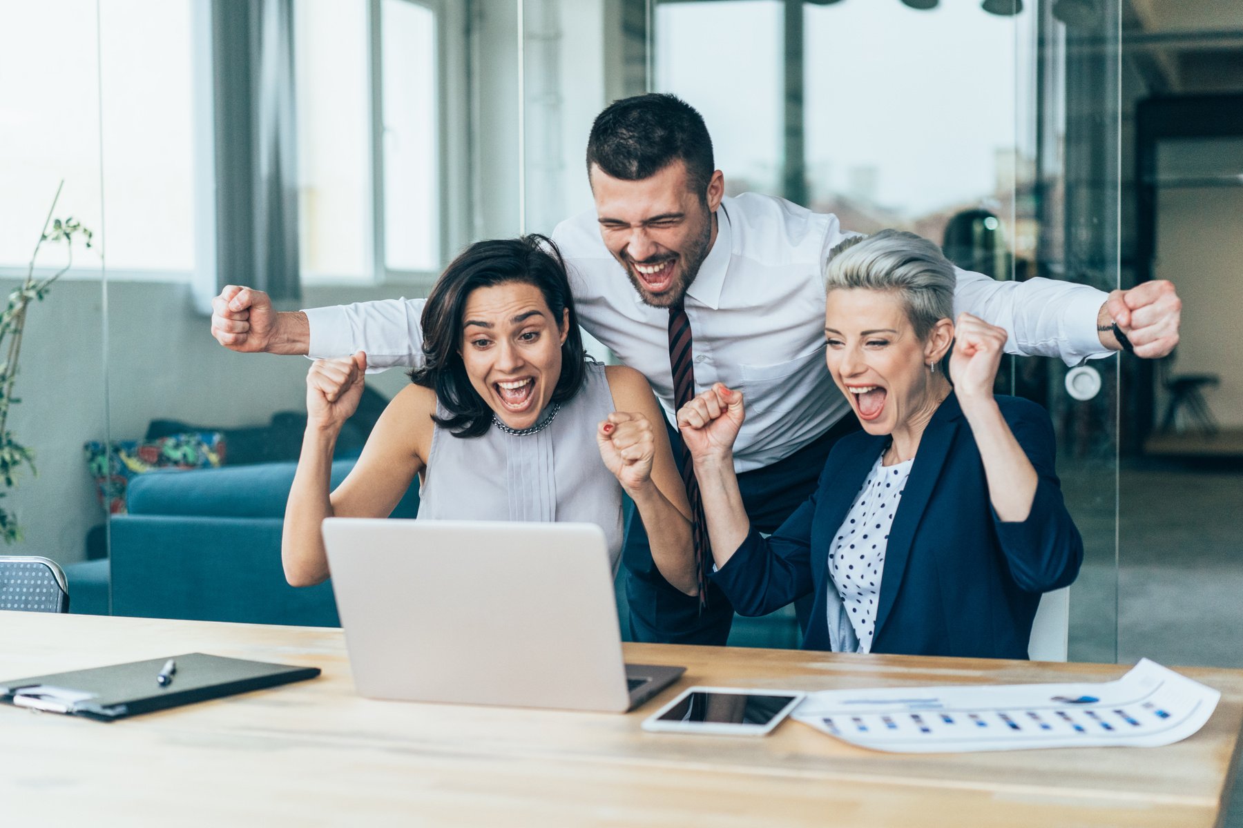 Three excited business persons